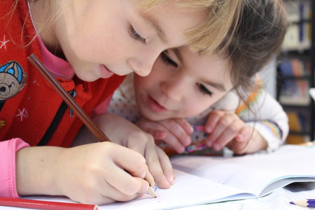 Two children writing