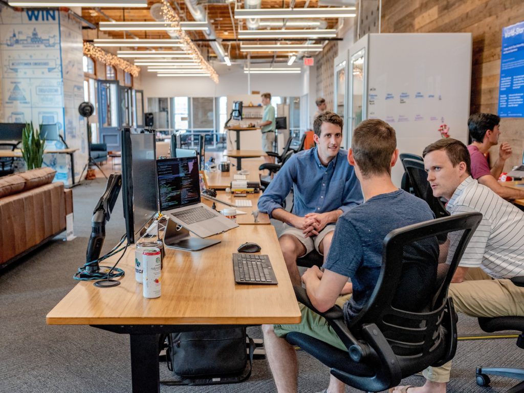 Three team members having a casual conversation at work